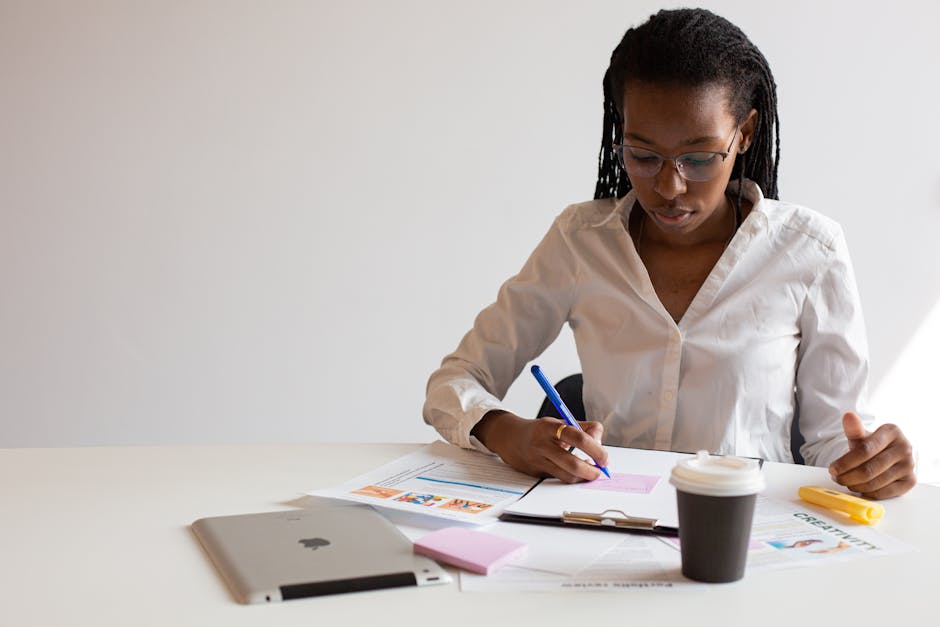 brazilian woman working focused at desk with notes