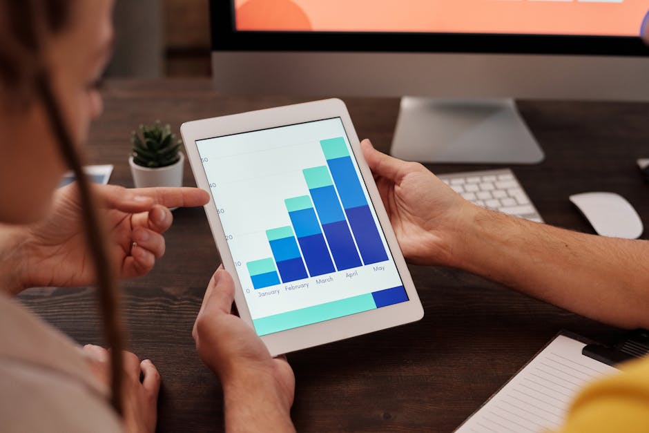 business analysis graphs on tablet in a cafe