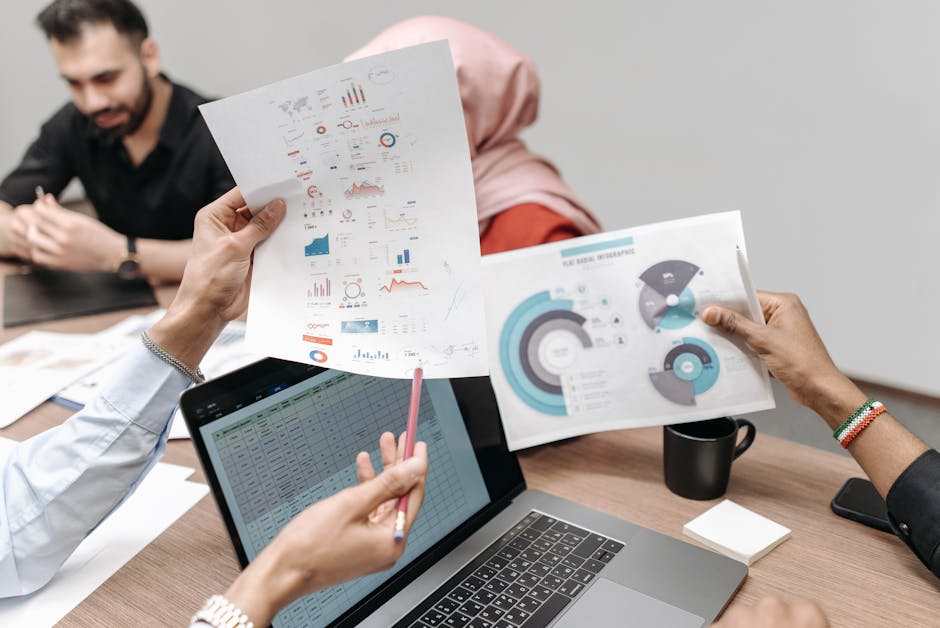 business meeting with diverse team and data visualizations