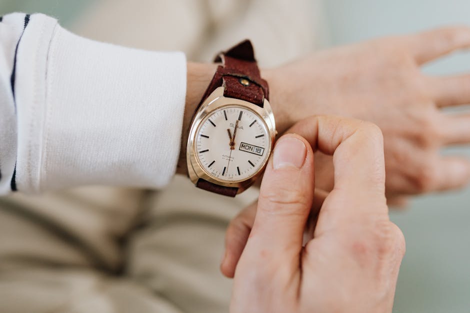 close up of women's hands adjusting classic watch and holding leather handbag