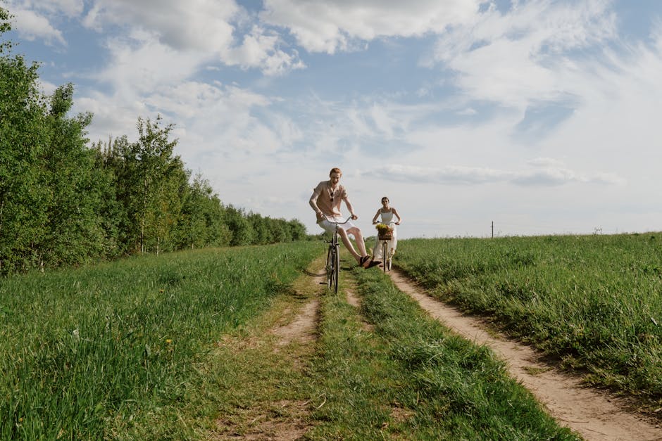 couple cycling through green landscape
