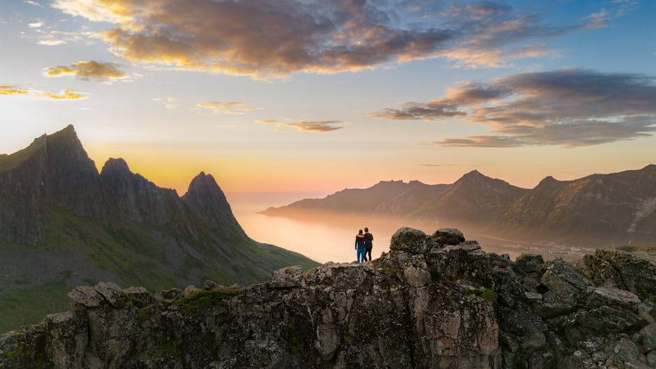 couple hiking in mountains at sunset