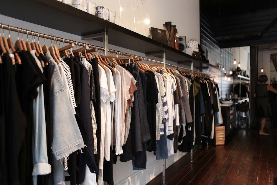 diverse selection of clothing items on hangers in a well organized vintage store