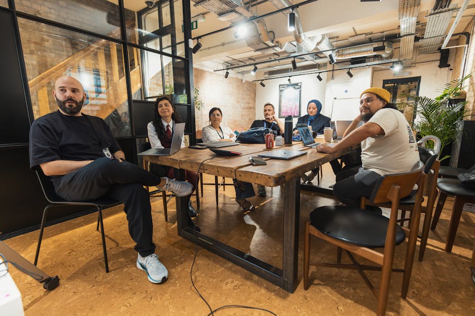 diverse team collaborating around a table with computers