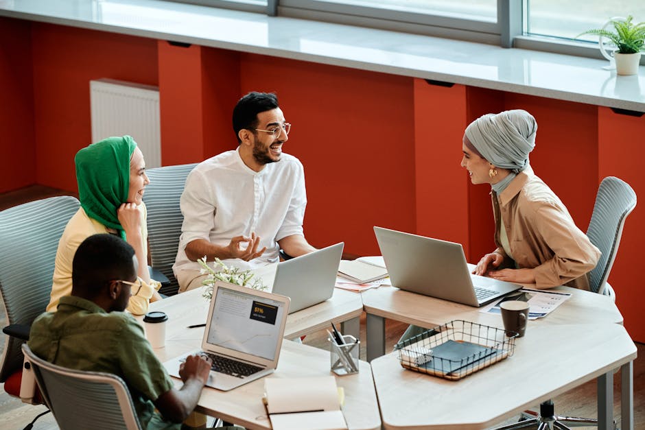 Diverse team collaborating with AI dashboard in modern office