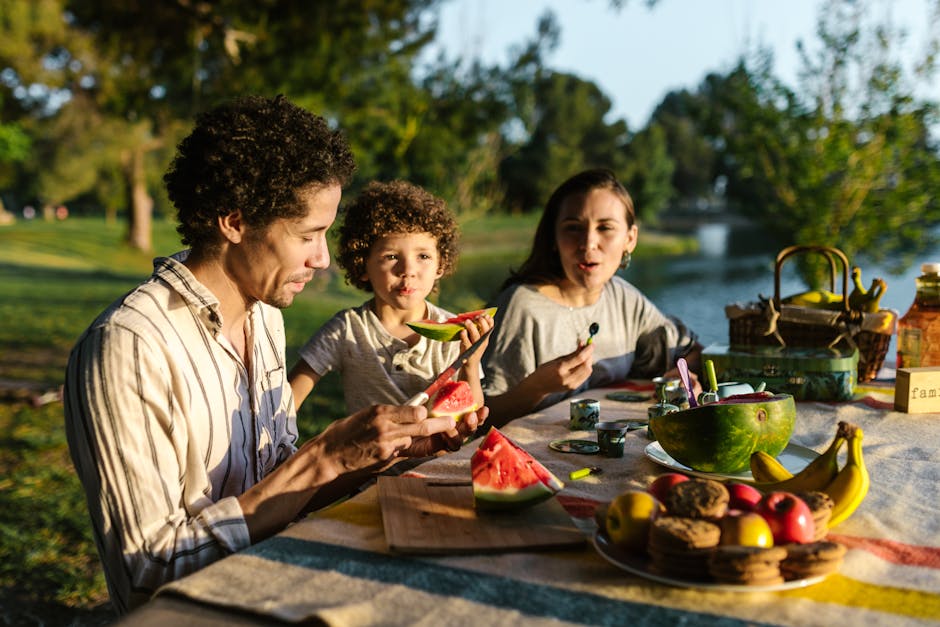 family eating picnic by lake
