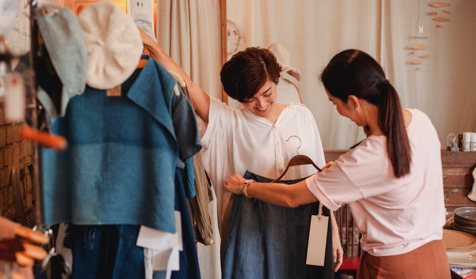 friends laughing while trying on clothes in a vintage store
