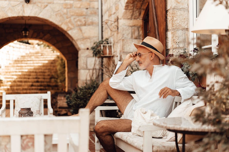 man in light linen shirt relaxing on summer terrace