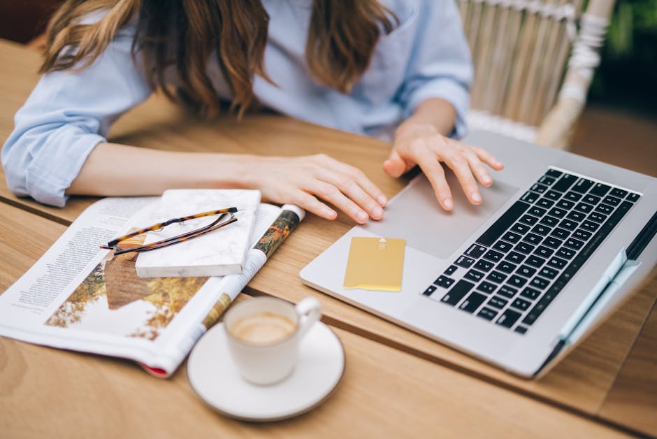 person happily working at laptop with coffee