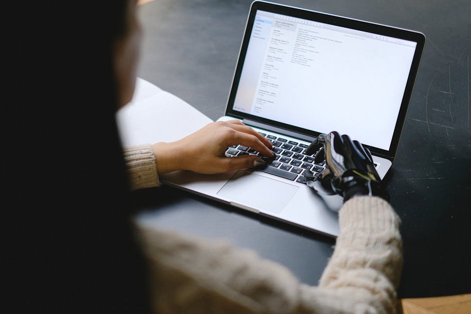 robot hand typing on keyboard
