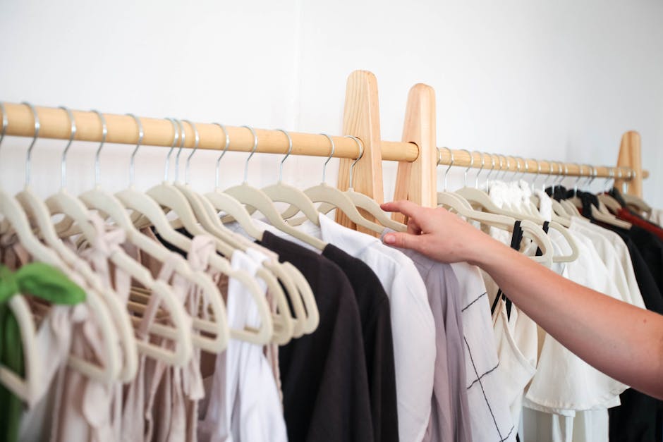 woman arranging clothes on a rail