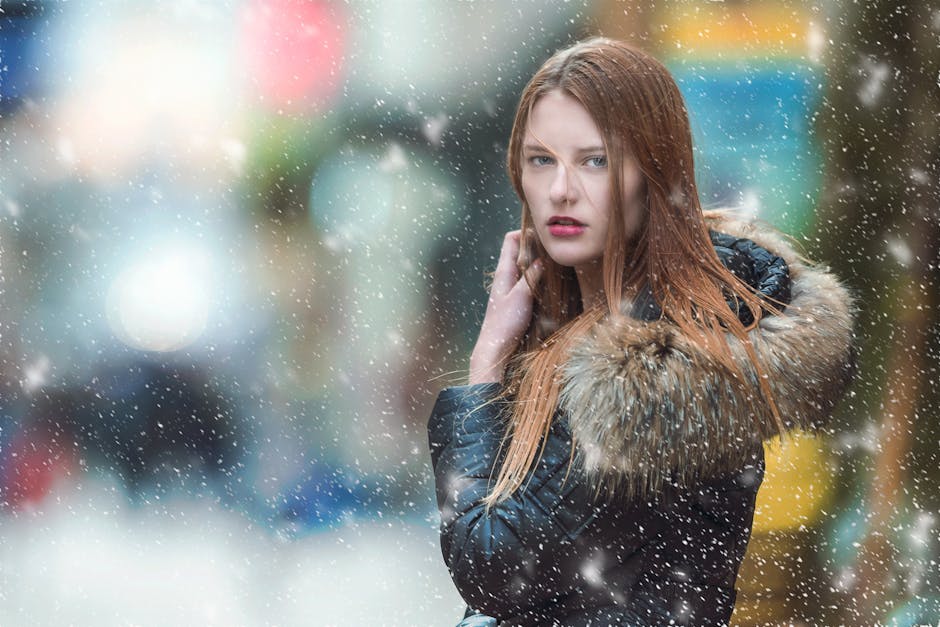 woman in winter coat in snowy city