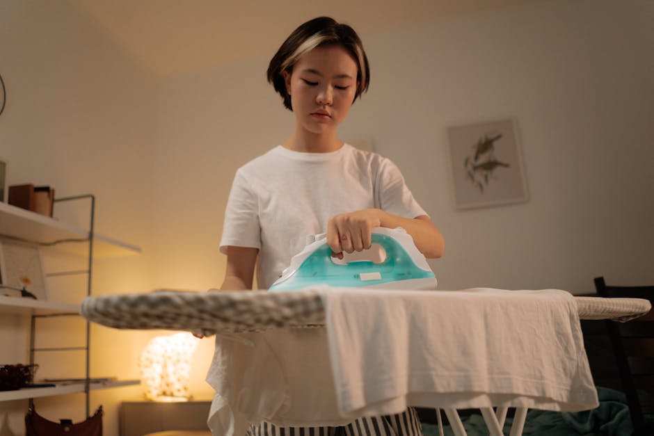 woman ironing white shirt