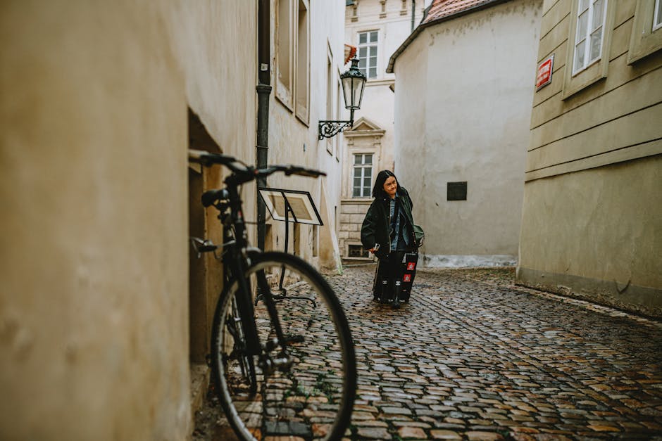 woman walking with backpack on cobblestone street