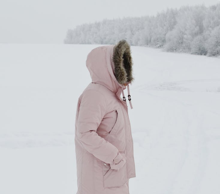 woman wearing warm winter coat in snow poland