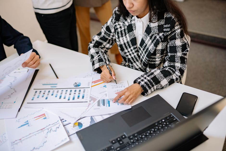 woman working on laptop with charts