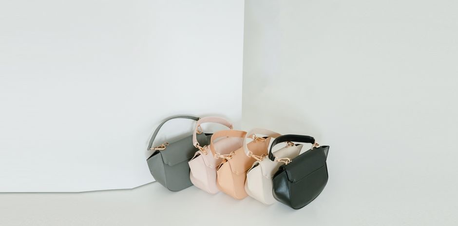 A display of various modern vegan leather bags, showcasing different styles and textures, made from innovative plant-based materials.