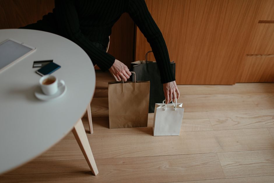 A stack of online shopping delivery boxes and a credit card, symbolizing successful online purchases and secure transactions.