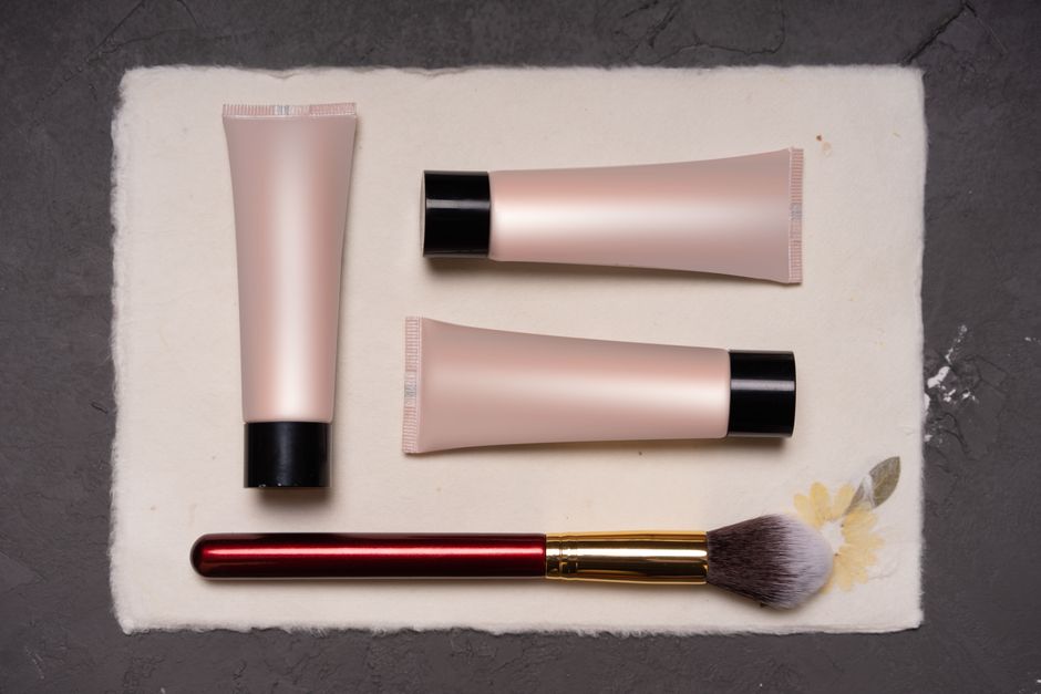 A flat lay photo of various budget-friendly beauty and skincare products like cleansers, moisturizers, and serums, illustrating affordable beauty products worth buying.