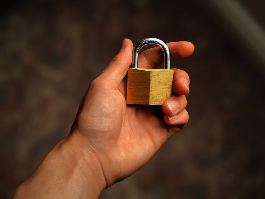 A shopping cart icon on a screen with a prominent padlock symbol, representing secure online transactions and safe e-commerce practices during sales.