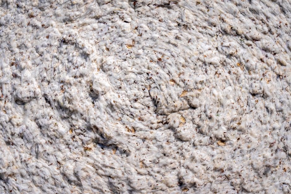 A close-up shot of a soft, textured fabric, possibly organic cotton or linen, highlighting the quality and feel of sustainable materials.