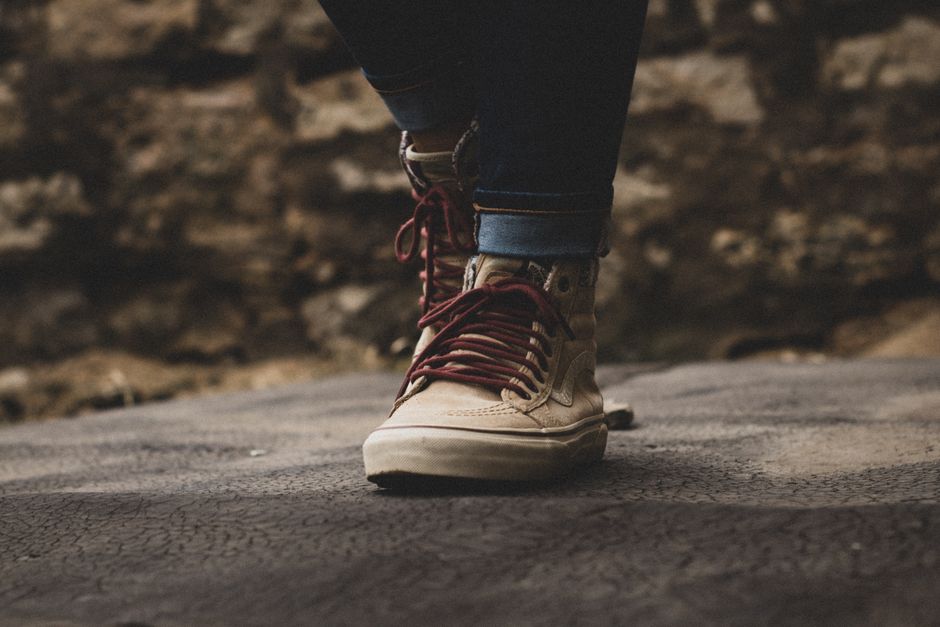 A close-up shot of the sole of a comfortable walking shoe as it treads on worn, historic European cobblestones.