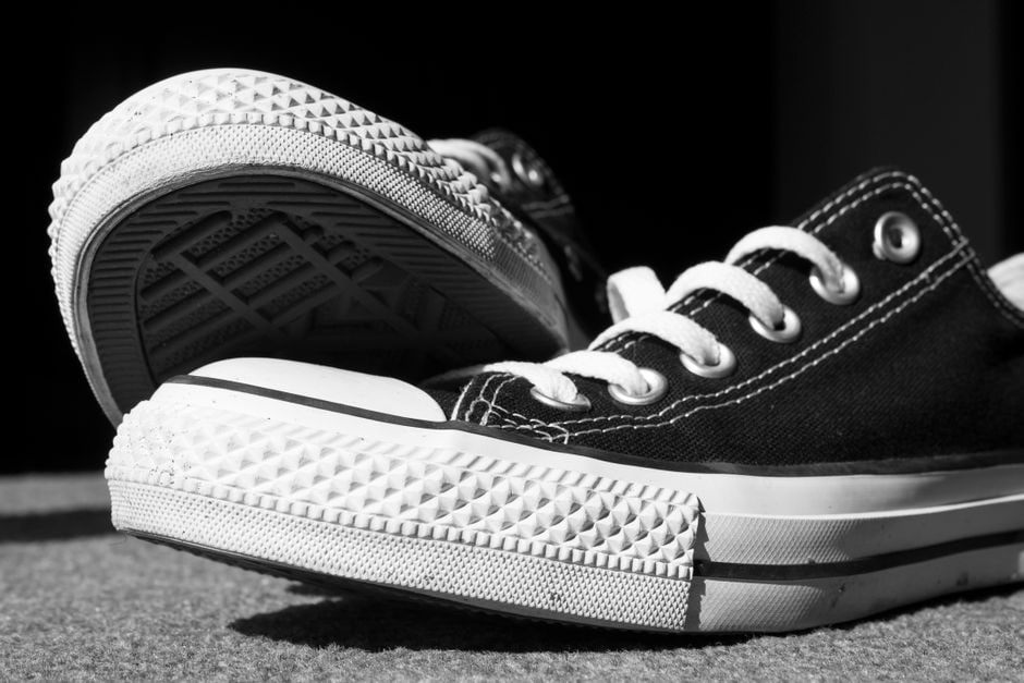 Detailed shot of various shoe soles, highlighting different tread patterns and cushioning layers for stability and shock absorption.