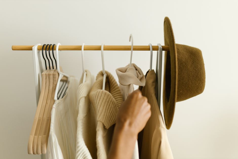 An open wardrobe showcasing a carefully selected women's capsule wardrobe with various high-quality, versatile garments in a harmonious color palette, demonstrating organized style.