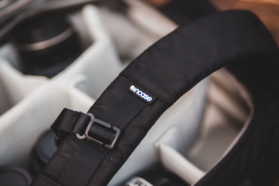 Close-up inside a laptop bag, showing a thickly padded, suspended compartment specifically designed to protect a laptop from impacts.