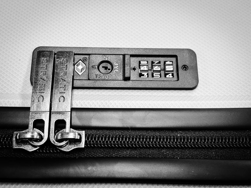 A collection of diverse travel bags – a backpack, a crossbody, and a carry-on – each highlighting features like anti-theft zippers, secure buckles, and hidden compartments.