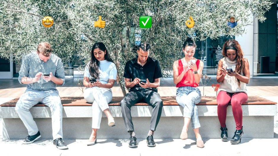 A family or group of friends on a trip, happily looking at a phone screen, potentially checking for local deals or attractions.