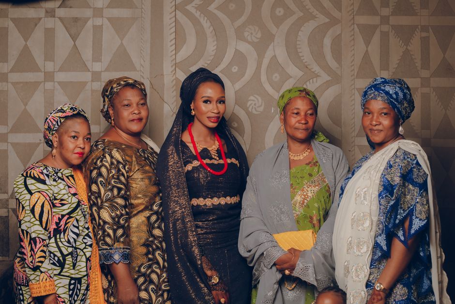 Group of diverse women chatting at a stylish dinner event, wearing comfortable yet chic affordable outfits, embodying various styles.
