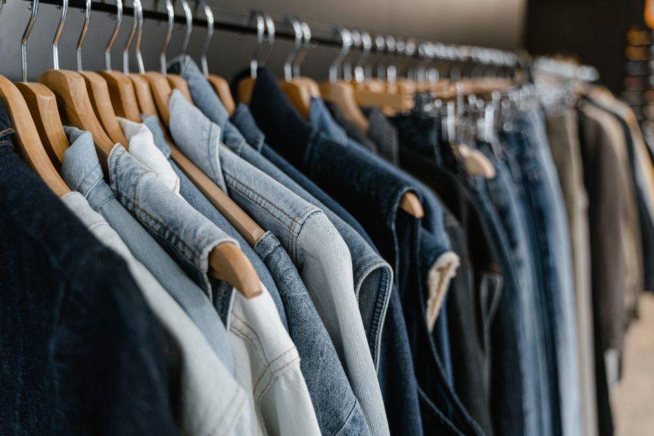 A rack displaying various women's jean styles, including skinny, straight, and wide-leg, in different washes