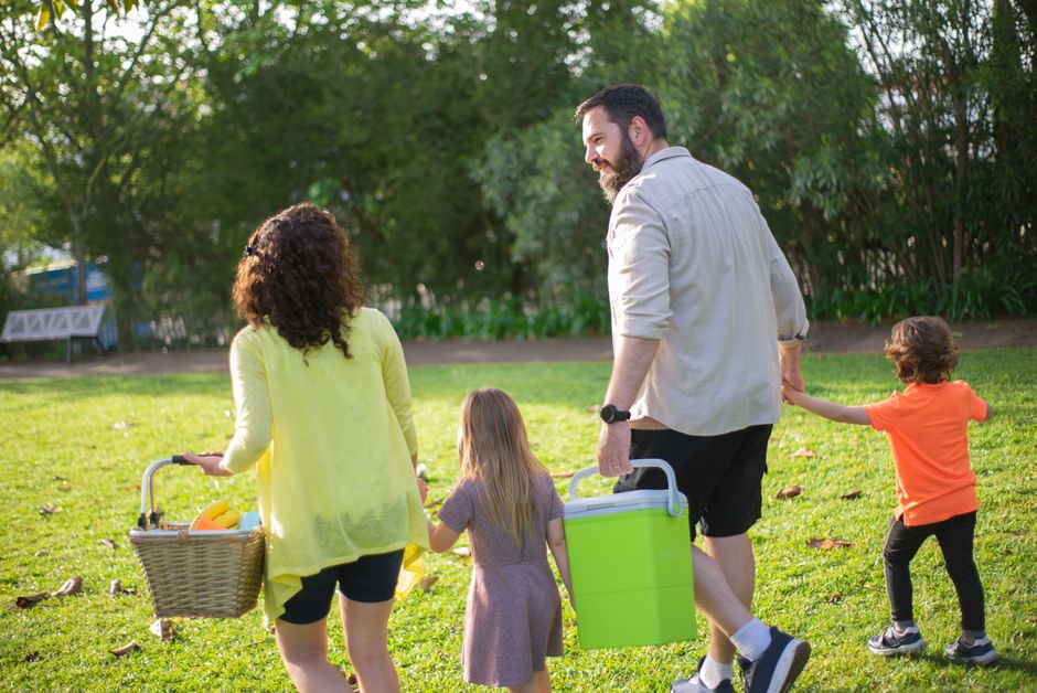 A family happily walking along a sandy beach at sunset, with an ocean view in the background, symbolizing a high-quality travel experience achieved through smart booking.