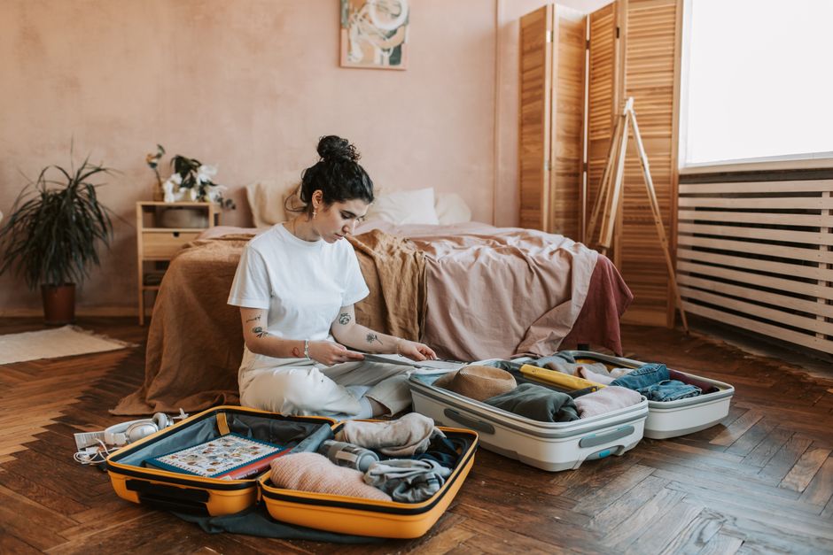An organized suitcase with a neatly packed capsule wardrobe for women, featuring versatile and comfortable clothing items for travel.