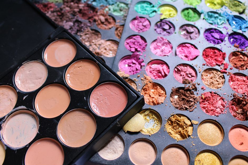 A close-up of a diverse range of foundation bottles and swatches, showcasing different undertones and shades.