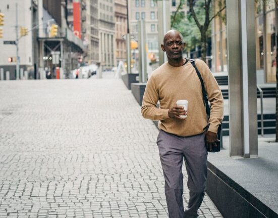 Man in stylish smart casual outfit walking through a European city street, ready for a date.