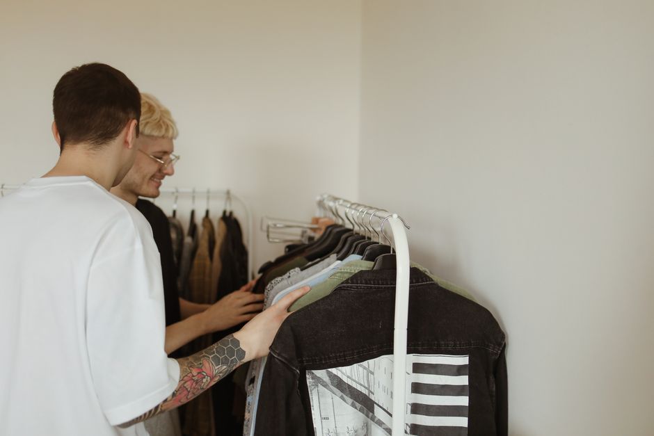 A neatly organized men's capsule wardrobe for summer, featuring linen shirts, chinos, and lightweight blazers, demonstrating how to build a useful wardrobe.