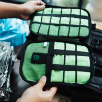 Close-up view of an open backpack with various organized compartments and pockets for tech gadgets and small essentials.