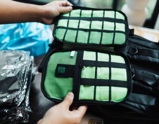Close-up view of an open backpack with various organized compartments and pockets for tech gadgets and small essentials.