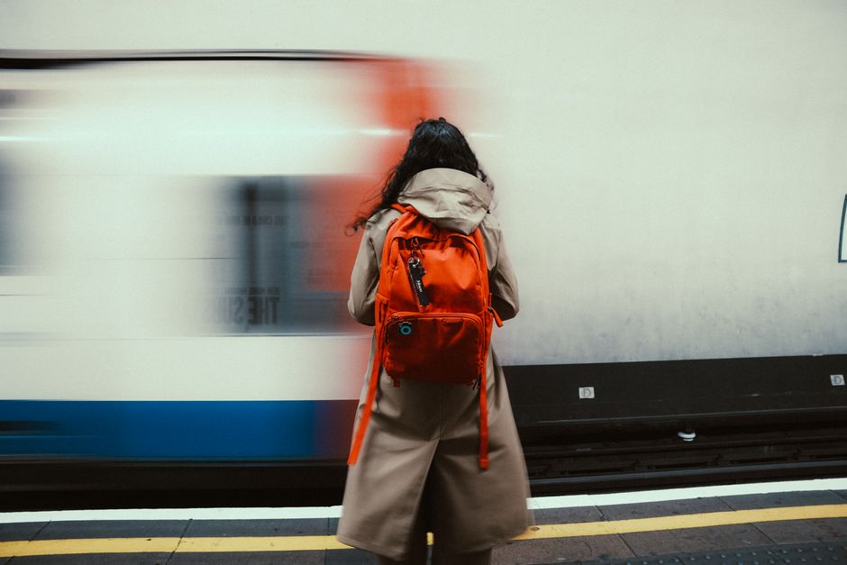 A professional walking with a modern, organized laptop backpack in an urban setting.
