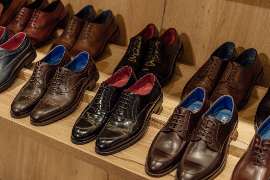 A curated display of various comfortable men's office shoes, including loafers, derbies, and smart sneakers, highlighting different styles and materials.