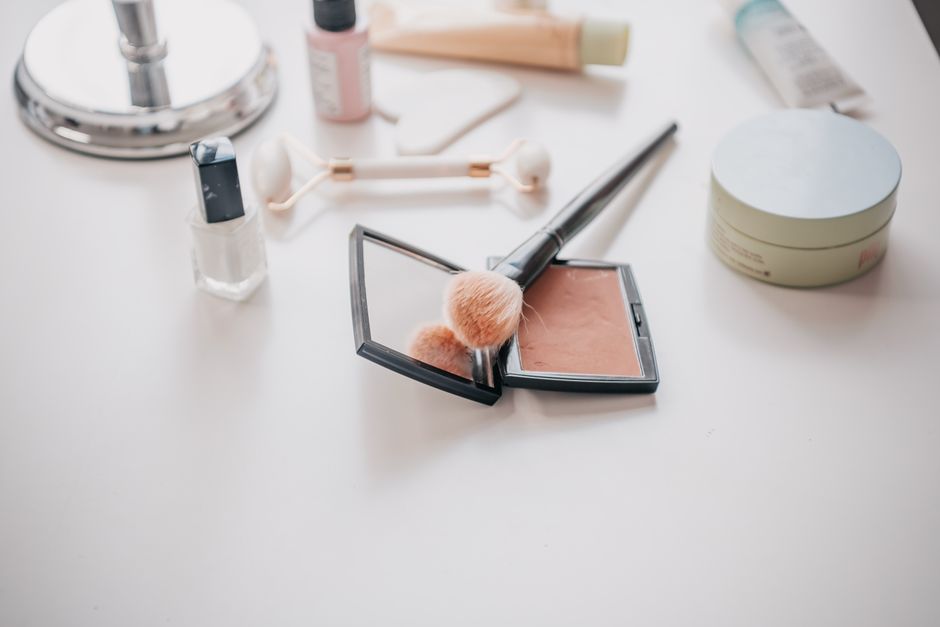 A neatly organized vanity with essential skincare and makeup products, including SPF, moisturizer, and a few makeup items, demonstrating a simple beauty routine.