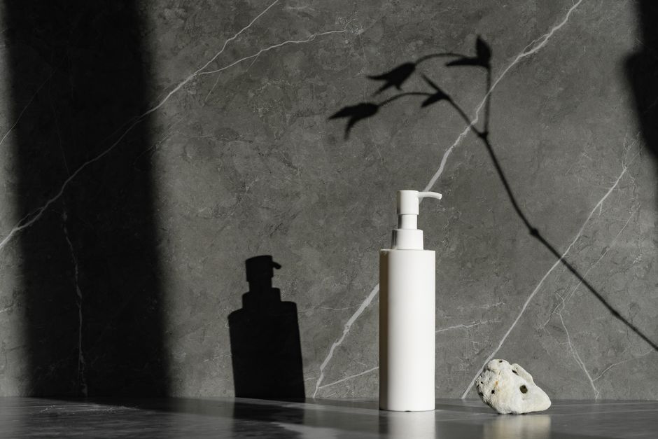 A collection of skincare products including SPF, serum, and moisturizer, neatly arranged on a bathroom counter, highlighting the importance of skin health.