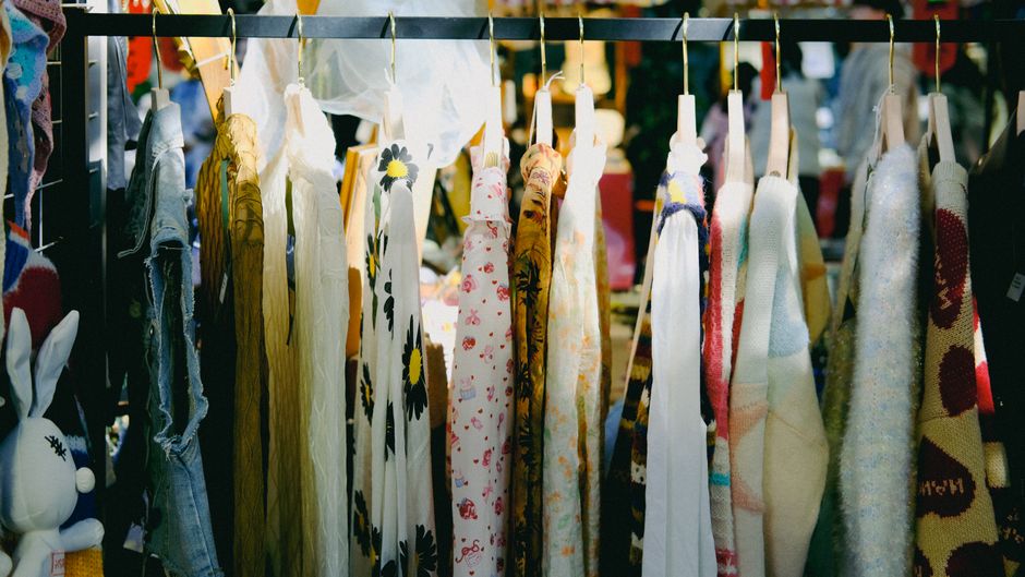 Close-up of a clothing rack displaying garments made from sustainable fabrics like linen and organic cotton, highlighting ethical fashion.