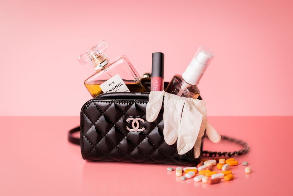 Various travel-sized skincare and makeup products neatly arranged in a clear toiletry bag, illustrating organized packing.