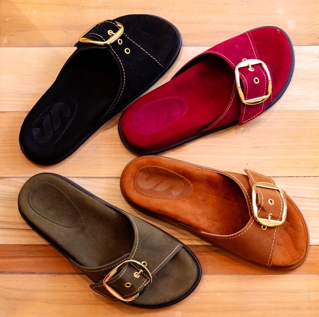 An assortment of high-quality summer sandals, featuring varied designs with prominent arch support, robust outsoles, and adjustable straps, suitable for long walks and travel.
